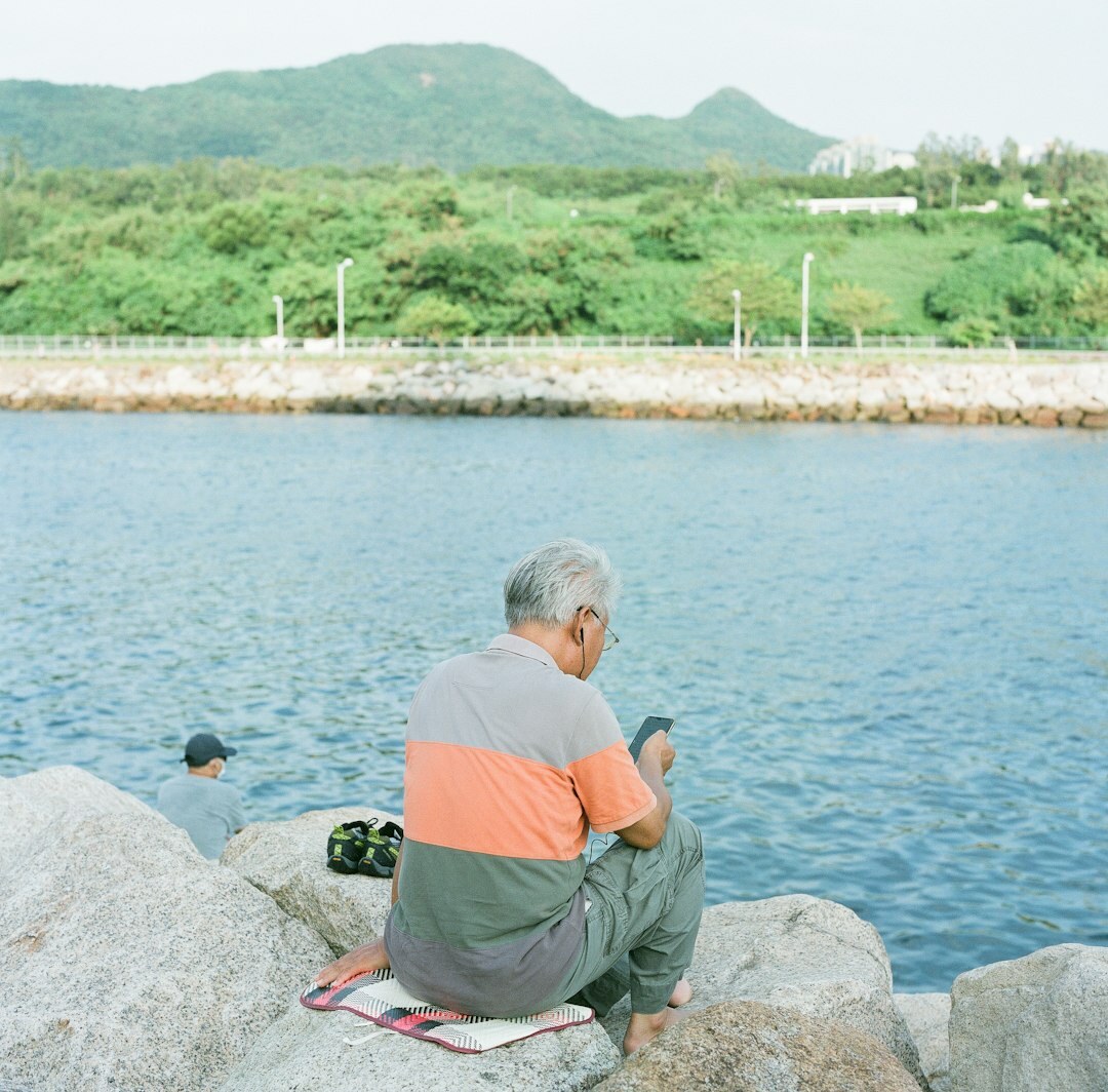 Chilean fisherman mending nets at a coastal harbor