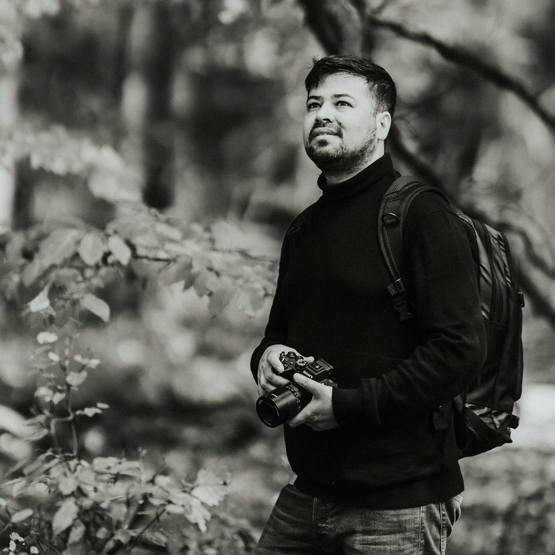 Portrait of a Chilean documentary photographer holding a camera
